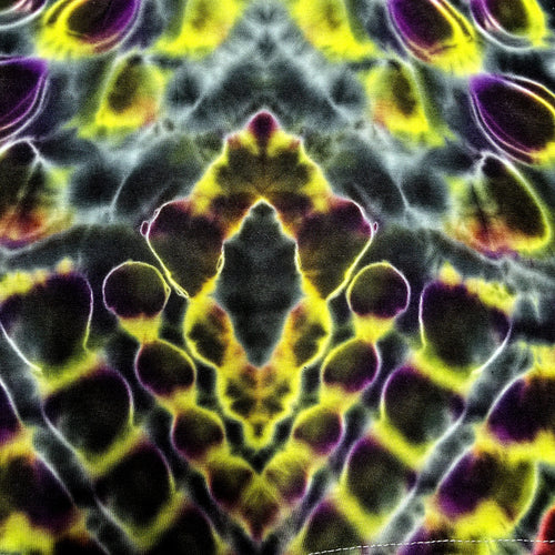 A close-up of a tie-dye fabric with a symmetrical, kaleidoscopic pattern in vibrant yellow, purple, black, and gray.