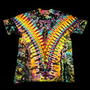 A short-sleeve tie-dye t-shirt with a vibrant, symmetrical rainbow pattern radiating from the center, shown flat against a solid black background.