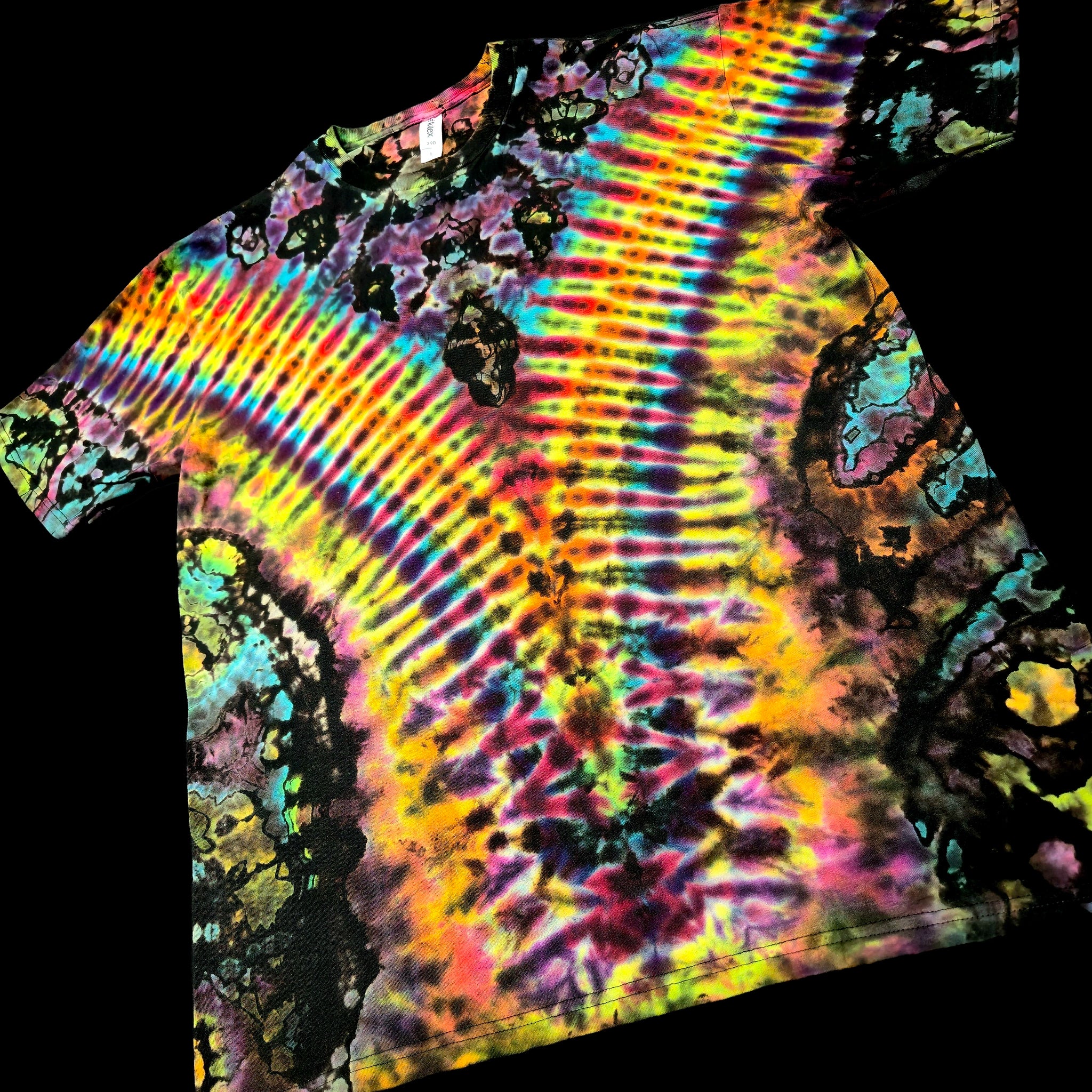 A short-sleeve tie-dye t-shirt with a vibrant rainbow spiral pattern, shown against a solid black background.