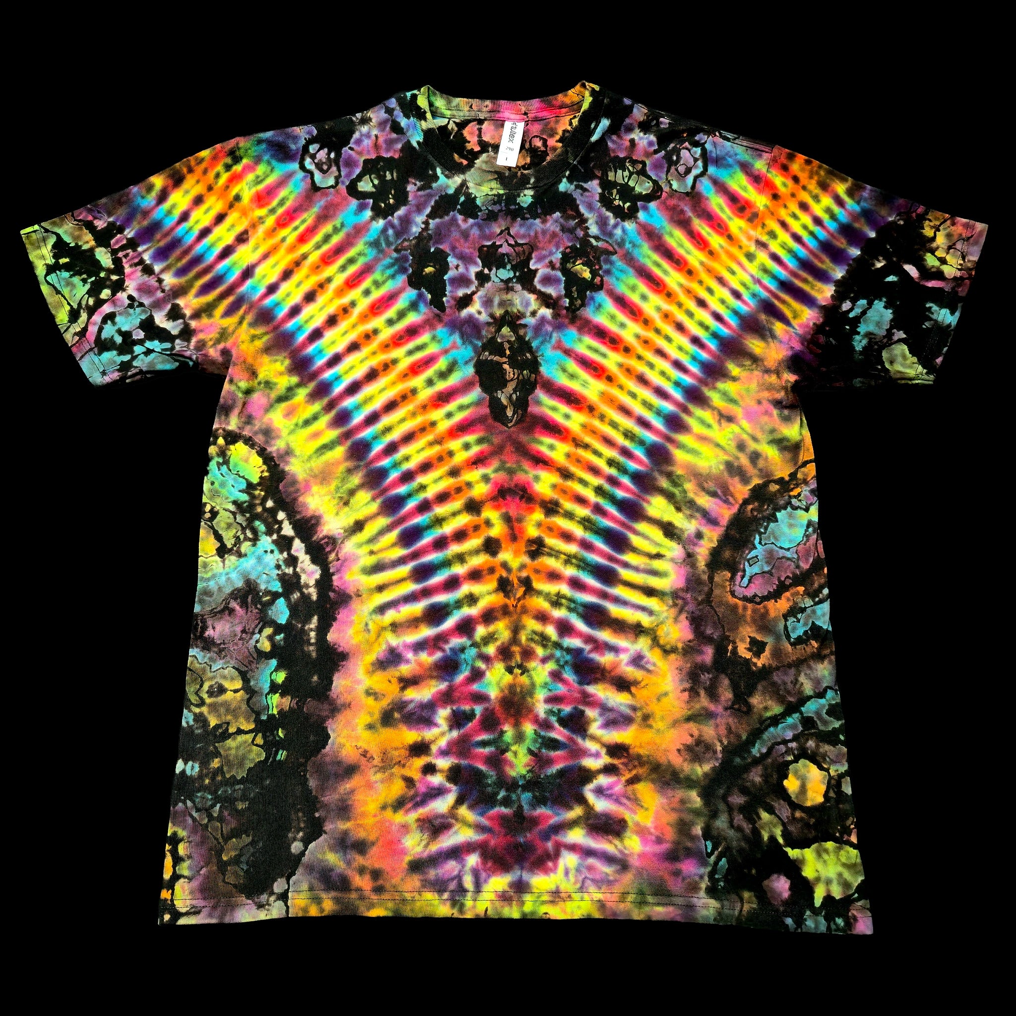 A short-sleeve crewneck tie-dye t-shirt featuring a vibrant, symmetrical psychedelic pattern with radiating rainbow stripes and dark organic splatters, shown flat against a solid black background.