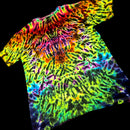 A short-sleeve tie-dye t-shirt with a vibrant spiral pattern of neon green, yellow, orange, pink, purple, and blue, displayed against a solid black background.