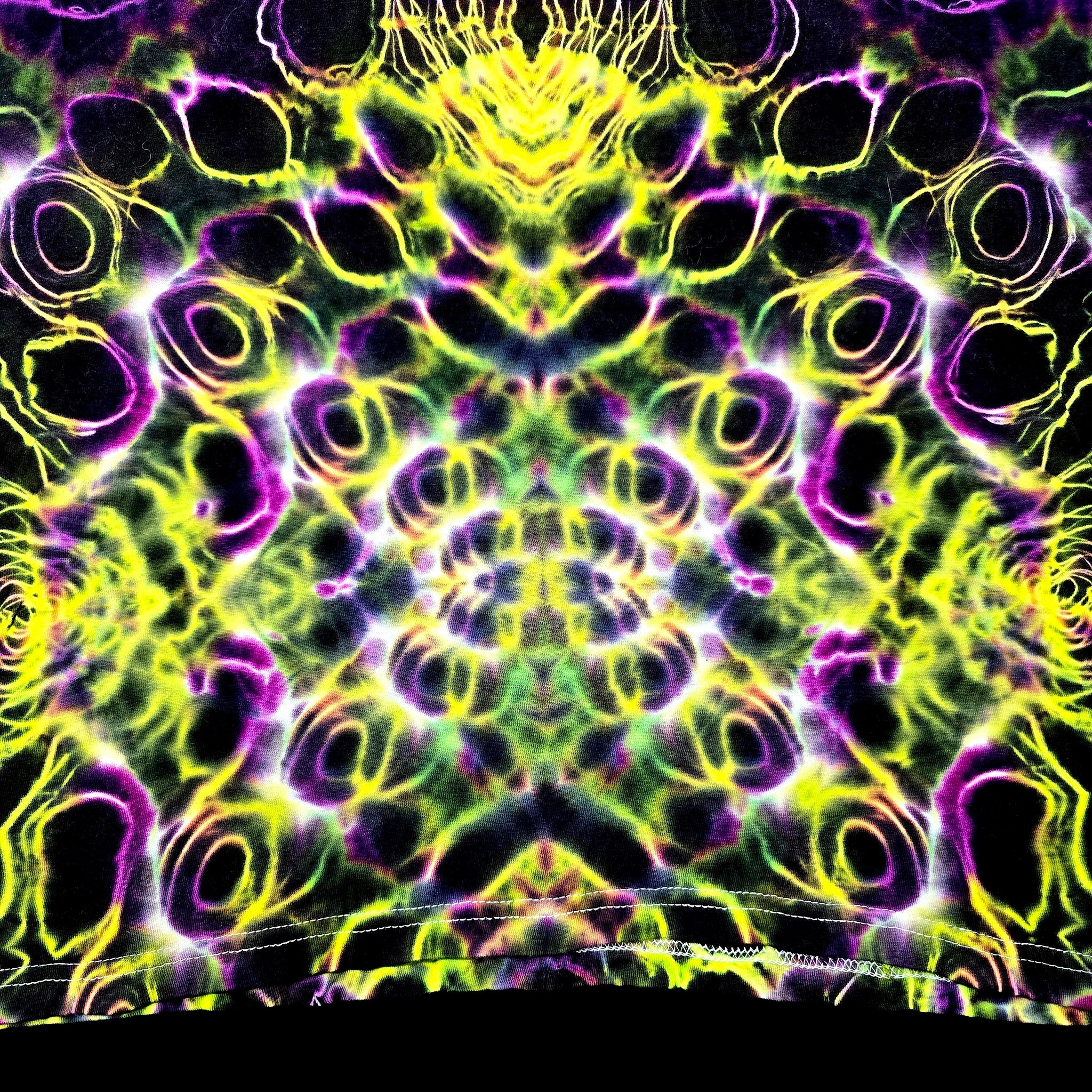 A highly vibrant, symmetrical psychedelic pattern featuring neon yellow, lime green, and magenta-purple glowing rings and organic shapes on a black background.
