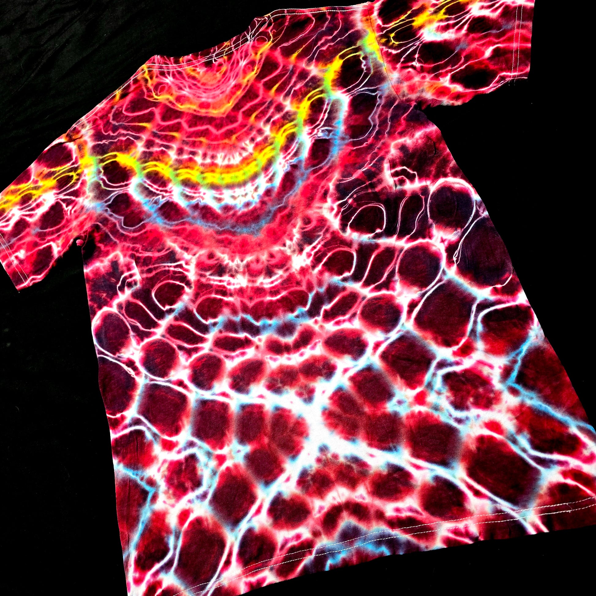 Angled back view emphasizing mirrored symmetry and vertical spine structure in red and white tie-dye