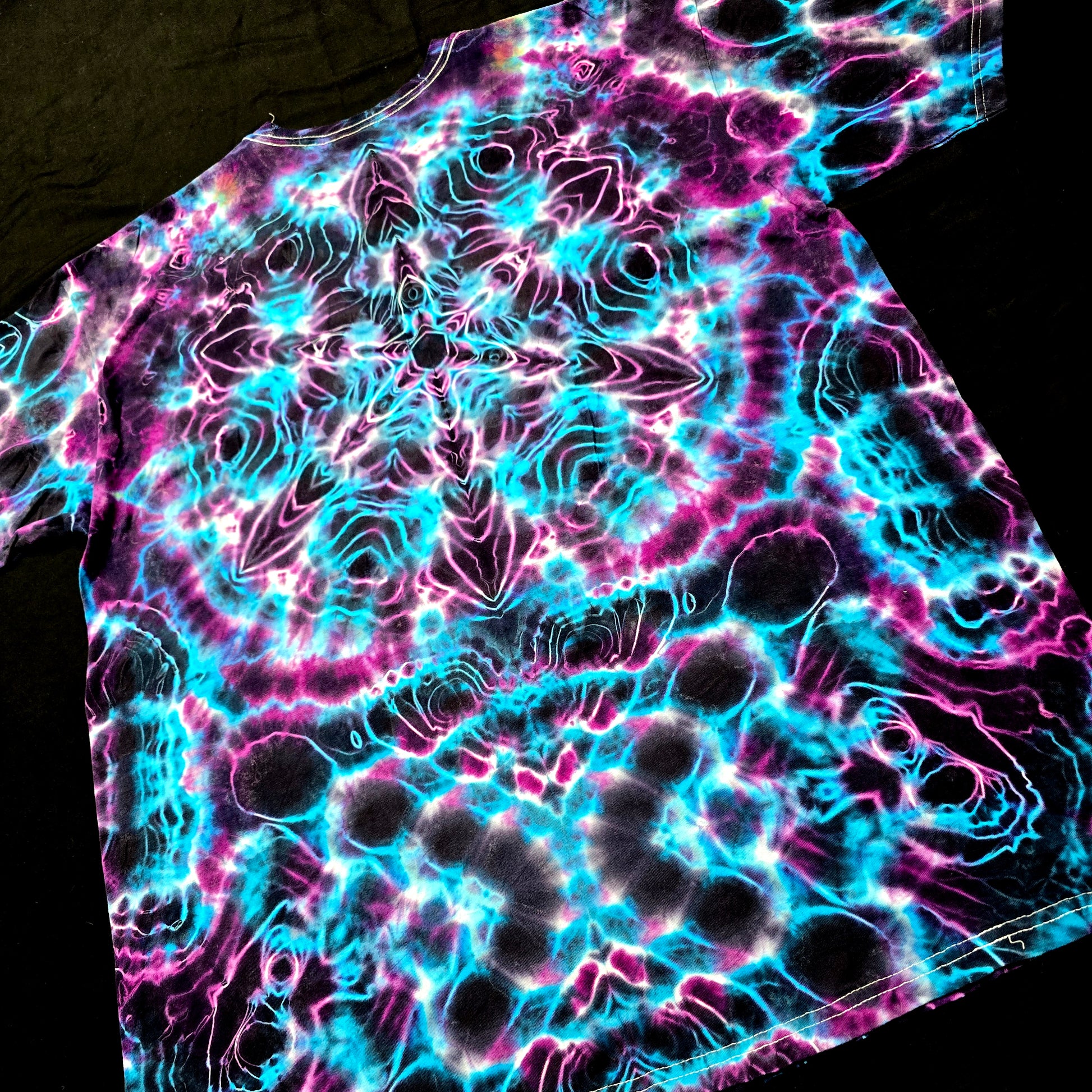 Neon tie-dye pattern on a black background
