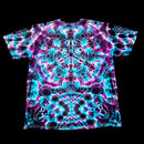 A short-sleeve crewneck t-shirt featuring a vibrant, symmetrical psychedelic tie-dye pattern in neon cyan, magenta, and purple on a black base, displayed flat against a solid black background.