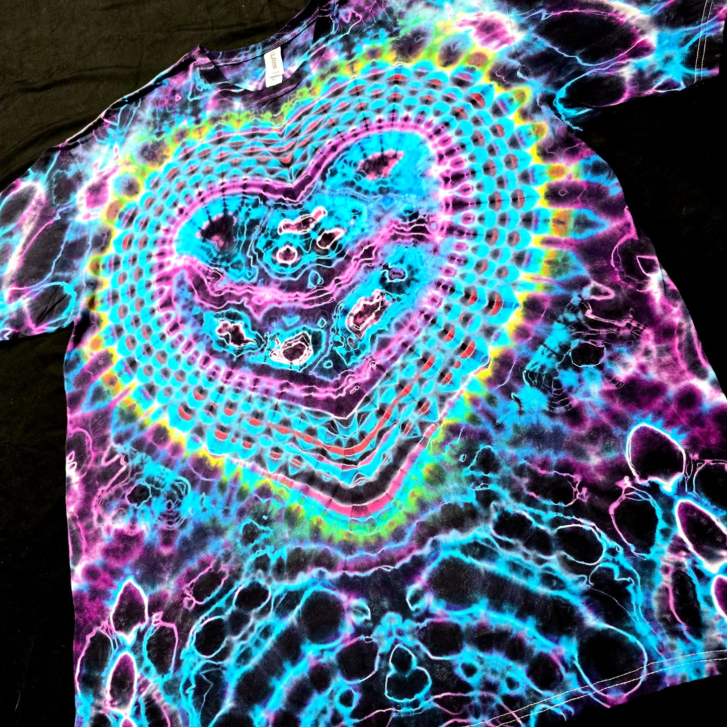 Angled front view highlighting glowing heart symmetry and saturated dye detail