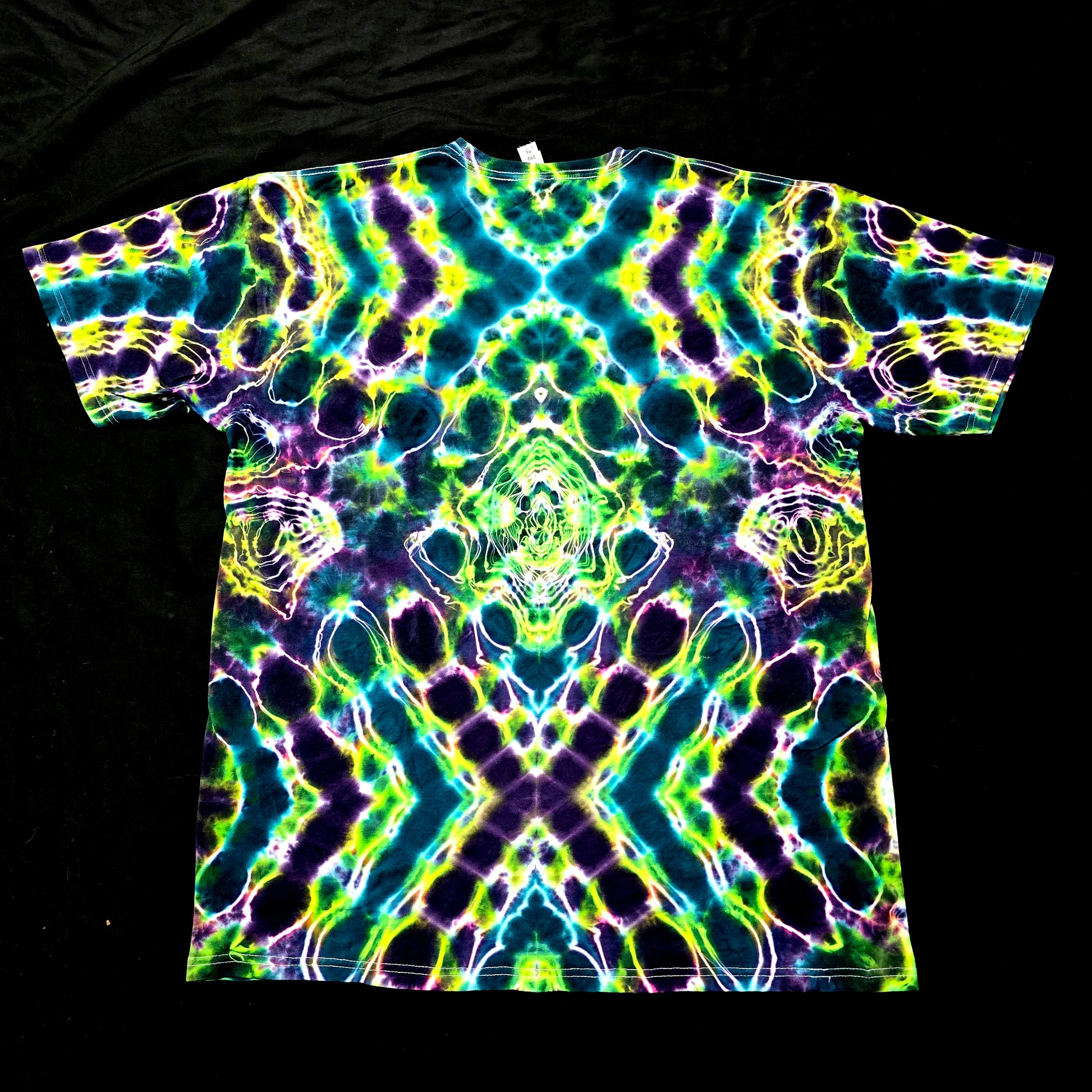 One-of-one handmade tie-dye shirt featuring bold X-shaped symmetry in green and blue, back view