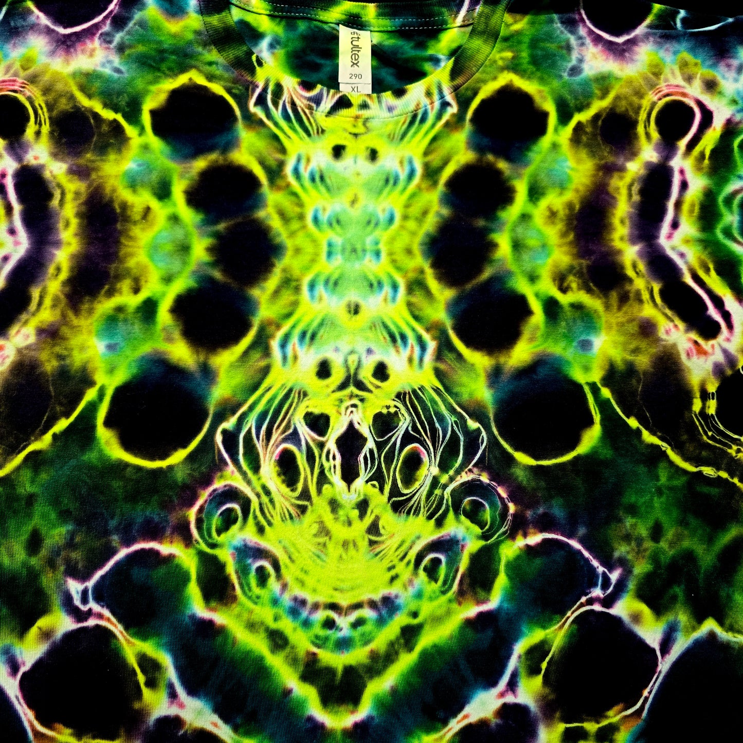 Colorful tie-dye pattern with a central design on a shirt.