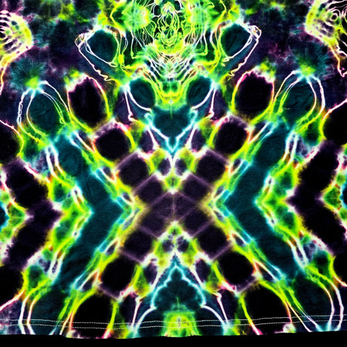 A close-up of a tie-dye fabric with a highly symmetrical, kaleidoscopic pattern featuring neon green, lime yellow, cyan, pink, and black.
