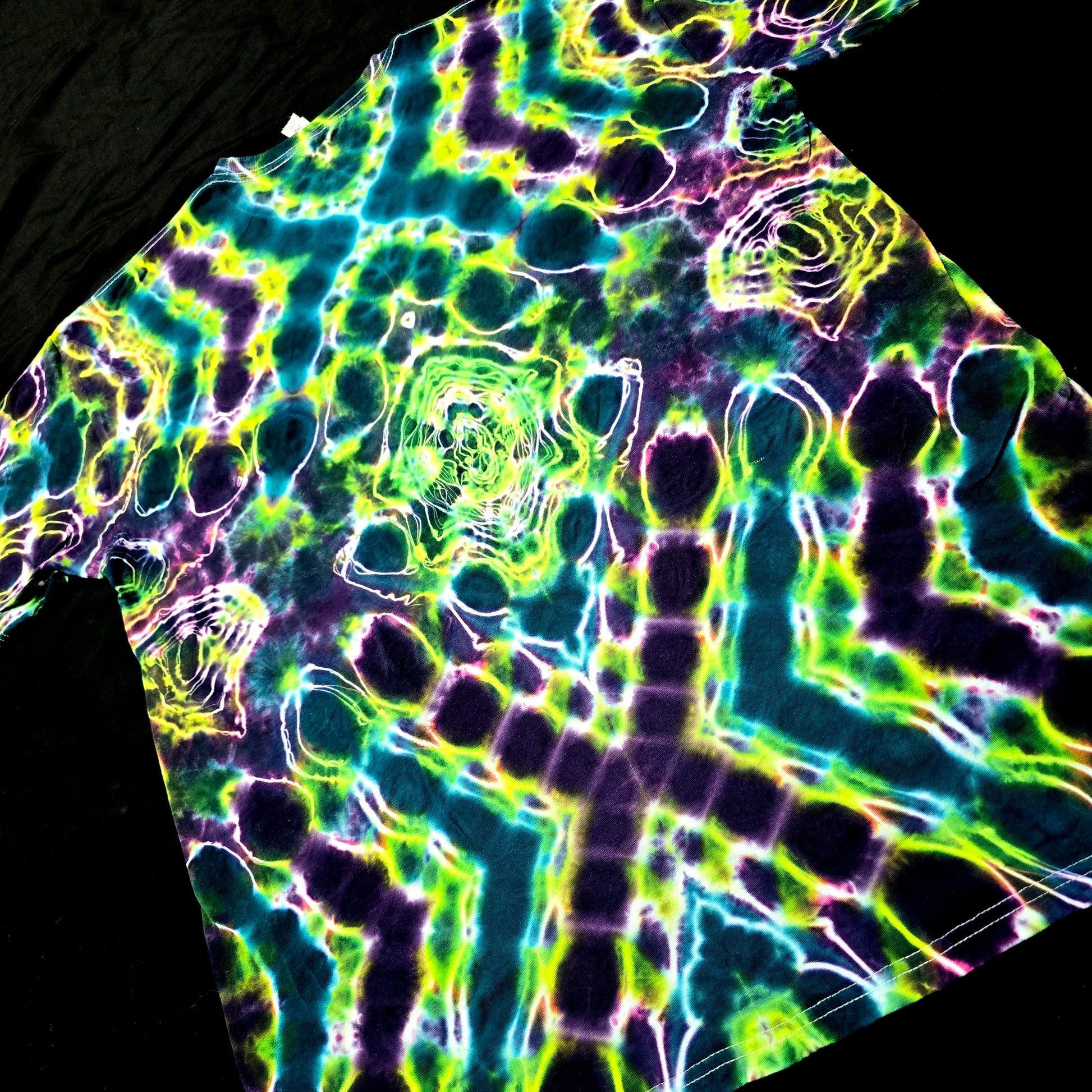 Angled back view highlighting mirrored Hyper X pattern on tie-dye shirt
