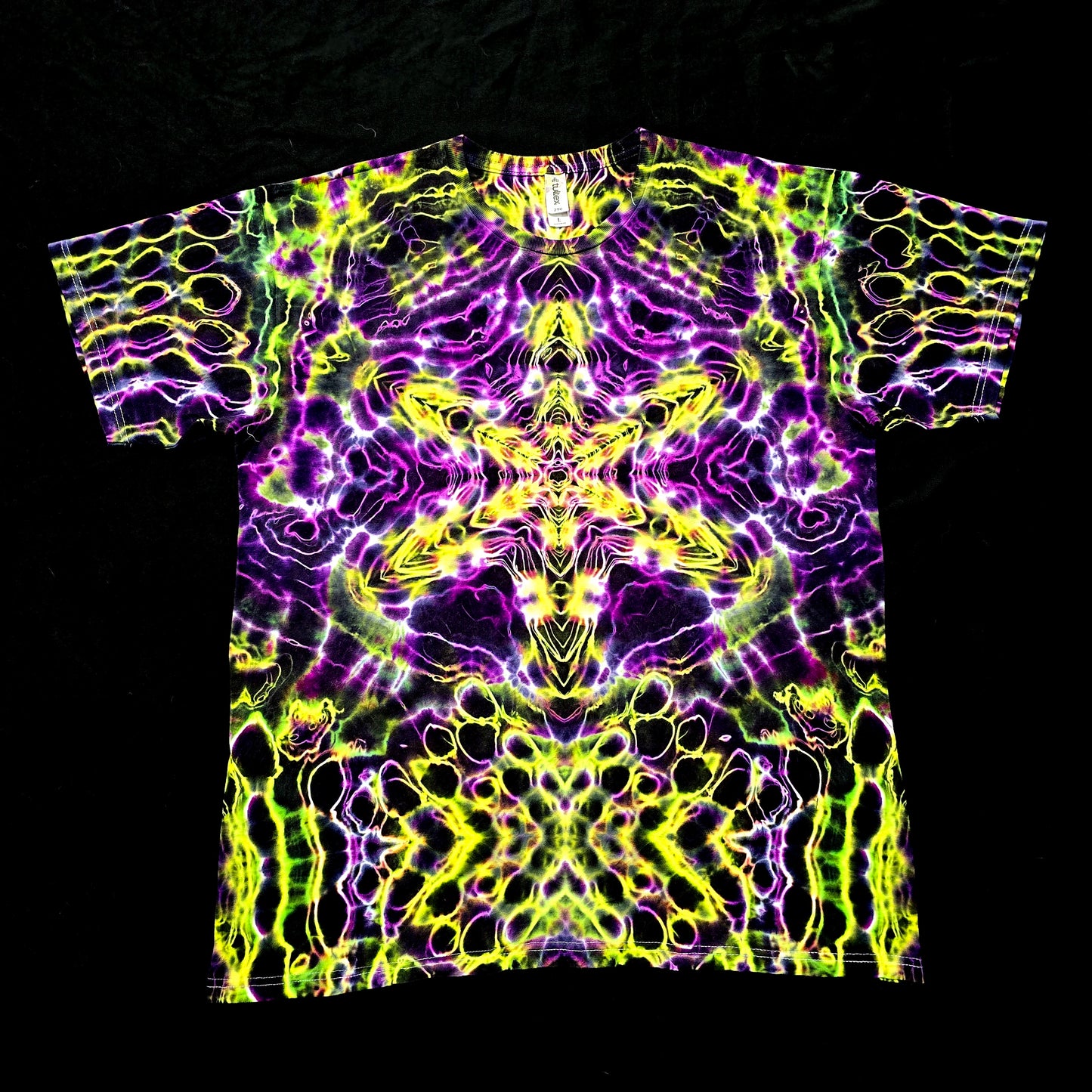Handmade tie-dye tee with neon yellow, green, and purple mirrored fractal pattern, front view