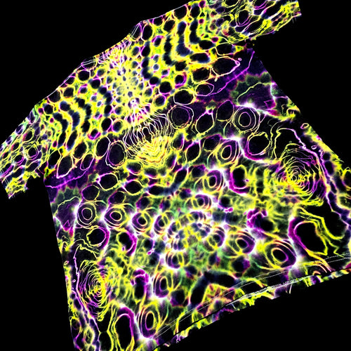 Neon patterned fabric with purple and yellow colors on a black background