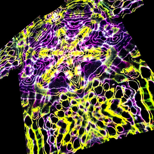 Tie-dye shirt with vibrant purple and yellow patterns on a black background