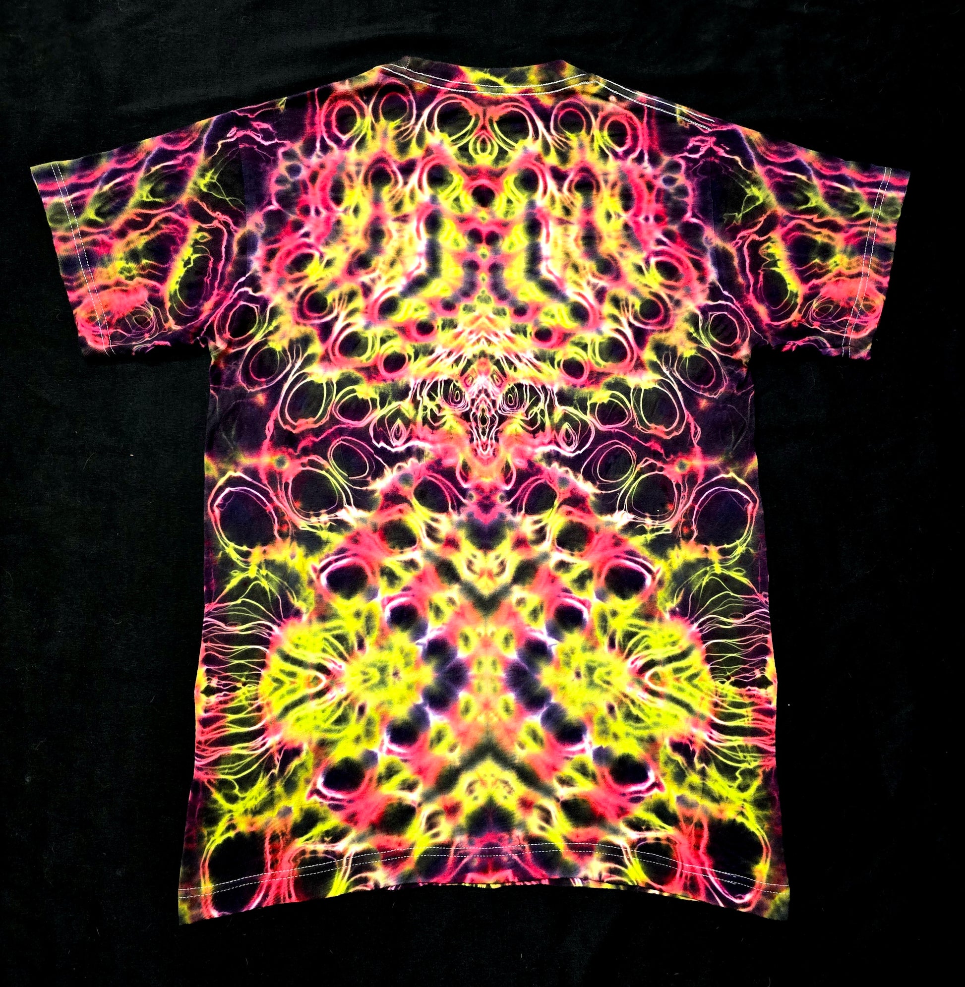 One-of-one handmade tie-dye shirt featuring neon pink and yellow symmetry, back view