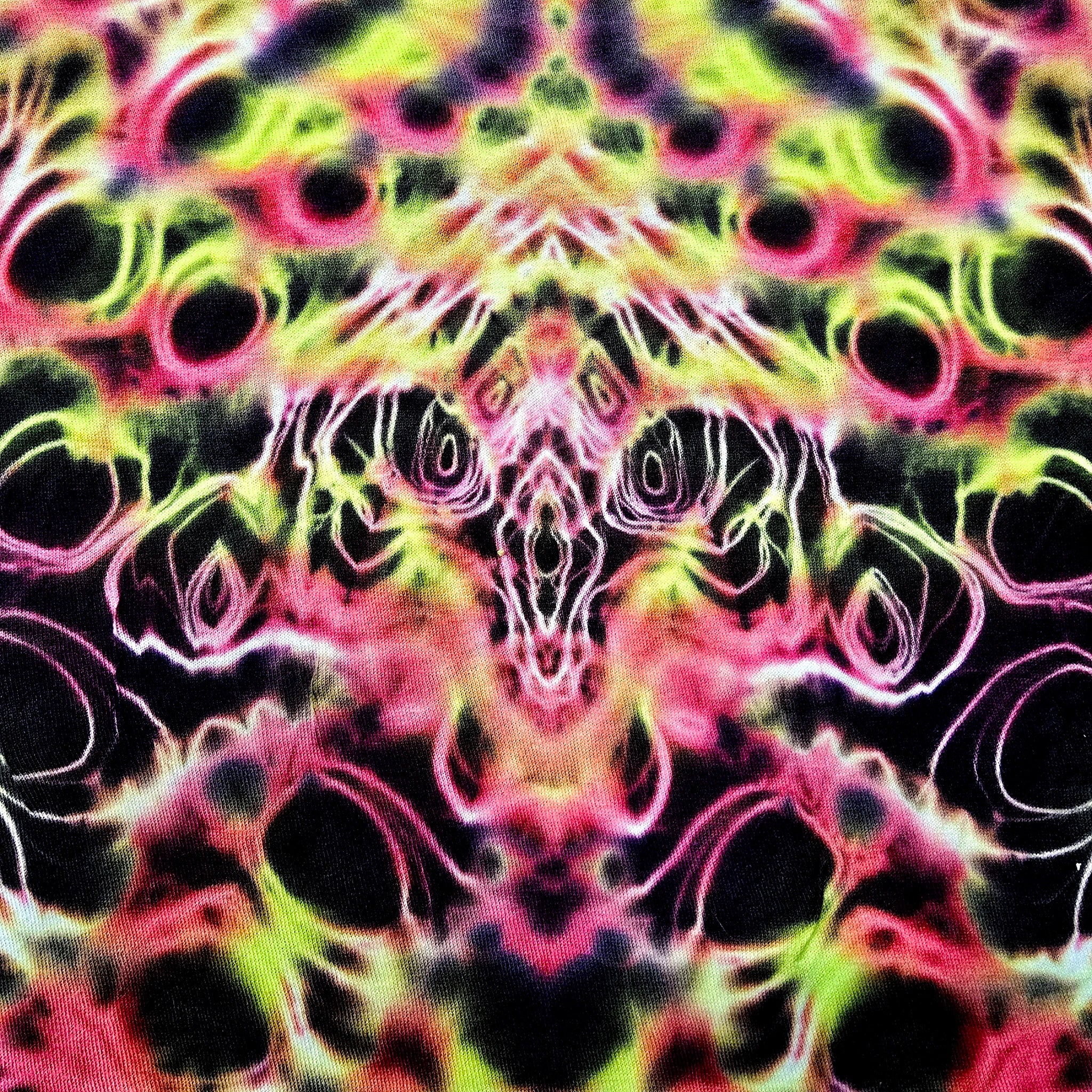 Colorful tie-dye pattern with black, pink, green, and yellow colors.