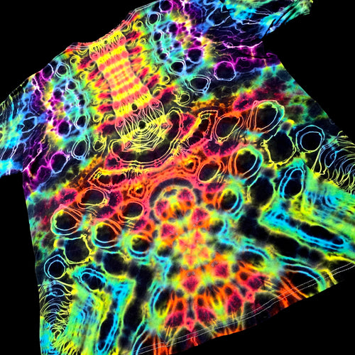 A short-sleeve t-shirt featuring a highly vibrant, psychedelic tie-dye pattern with neon colors including pink, yellow, green, blue, and purple on a black base, shown against a solid black background.