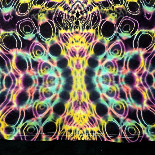 Close-up of front bottom tie-dye pattern featuring dense circular dye cells with neon outlines and dark negative space
