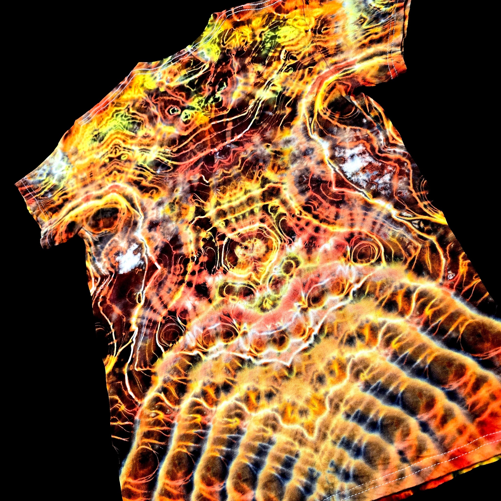 Angled back view of handmade tie-dye tee emphasizing the V spine-like symmetry and flowing electric dye textures
