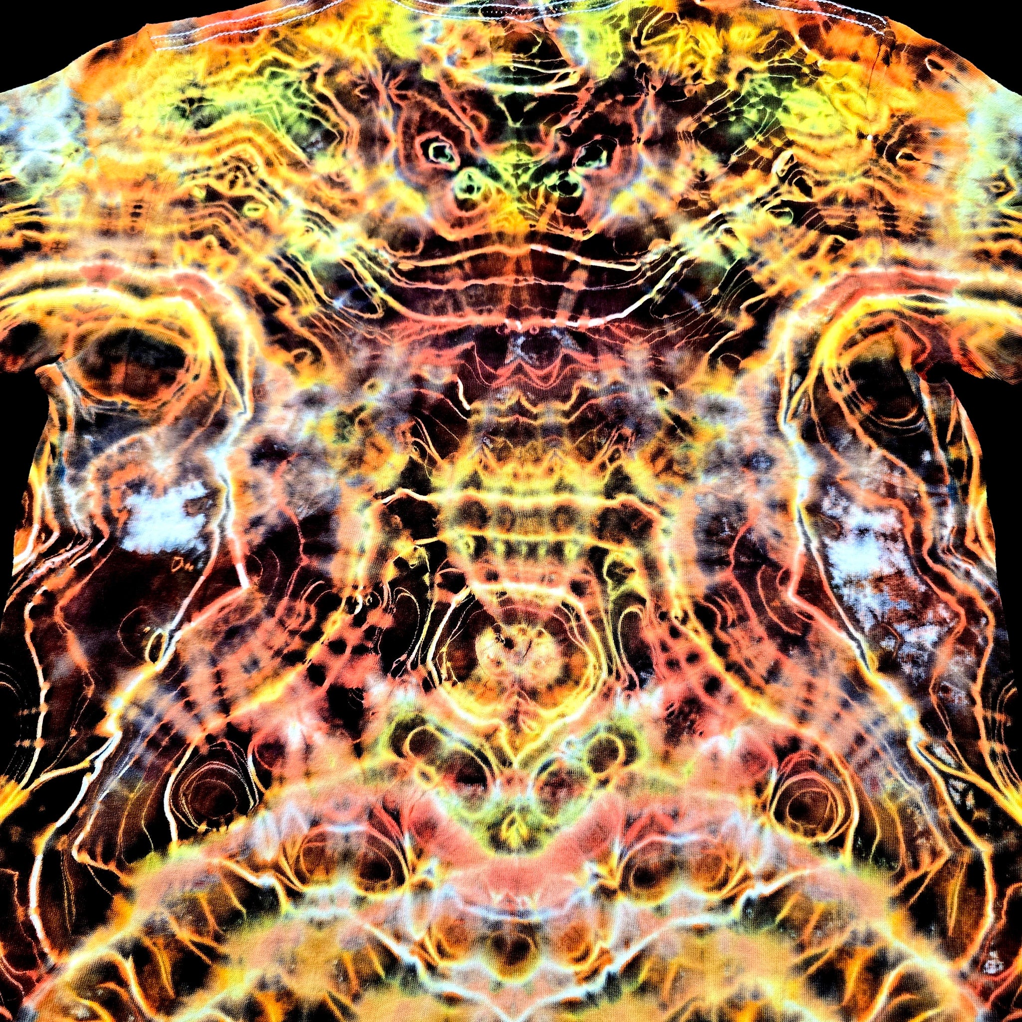 Angled back view of handmade tie-dye tee emphasizing the V spine-like symmetry and flowing electric dye textures
