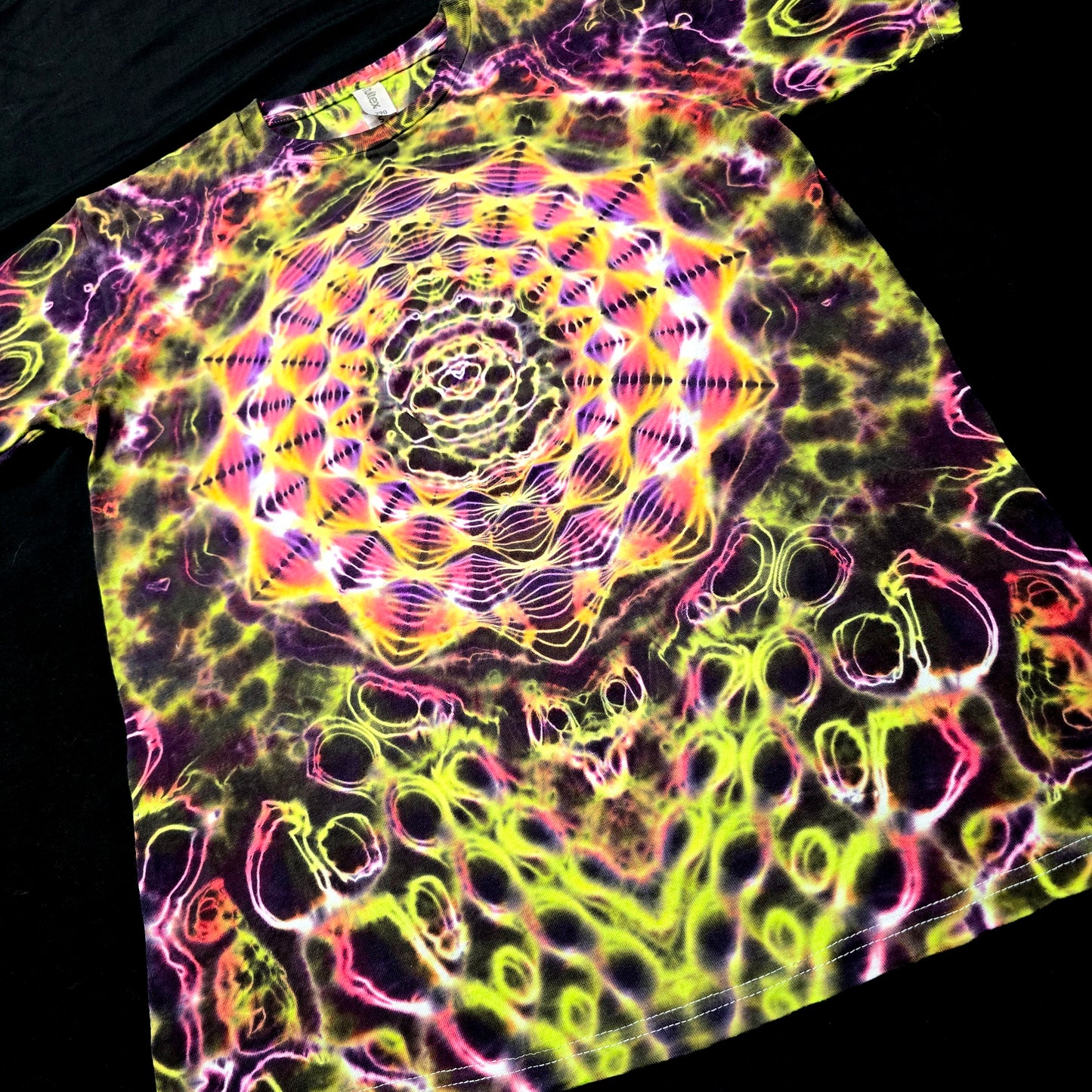 Angled front view highlighting depth, saturation, and layered Hyper X geometry in the Solar Pulse Veil tie-dye design
