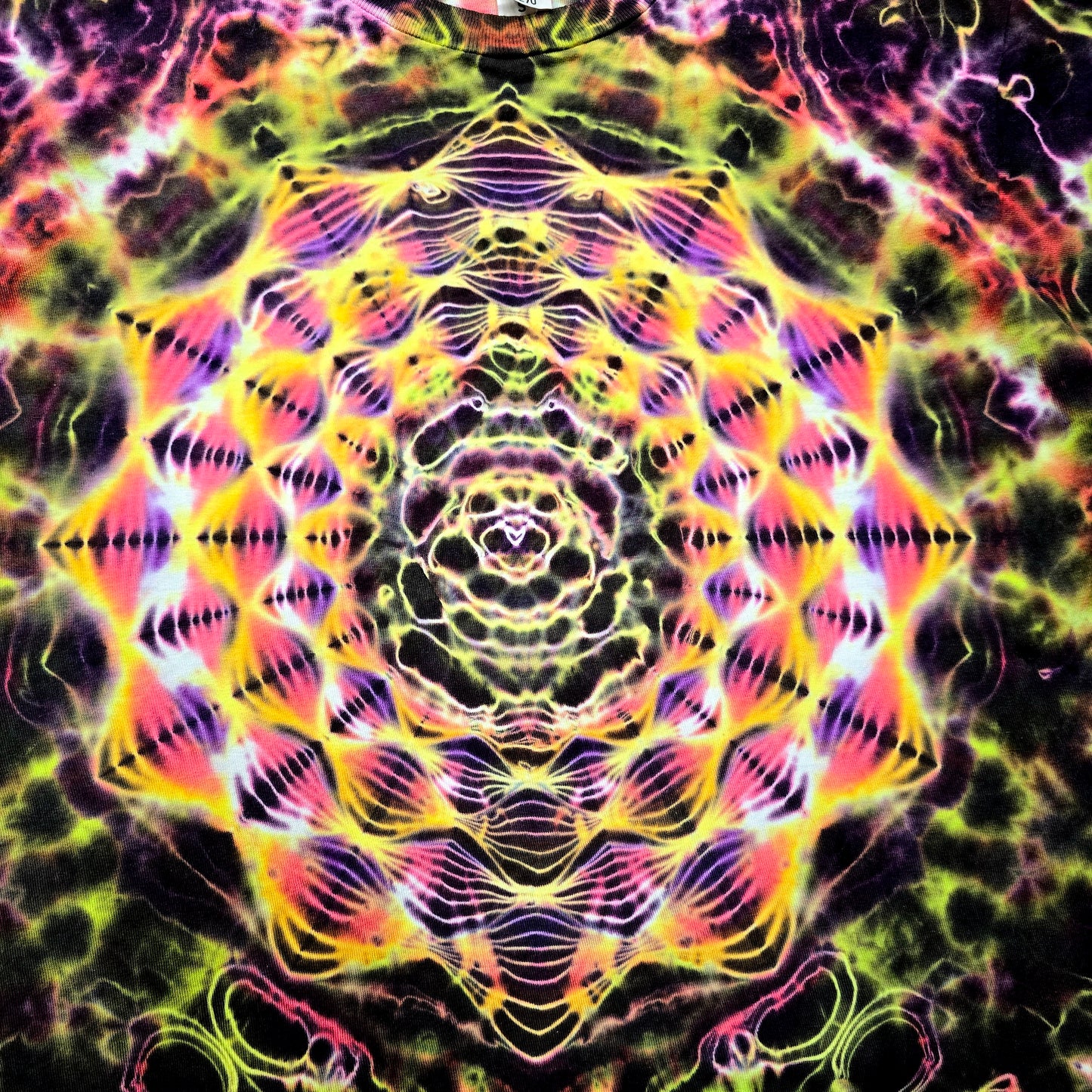 Close-up of the Hyper Fractal mandala showing fine resist lines and high-contrast neon color separation
