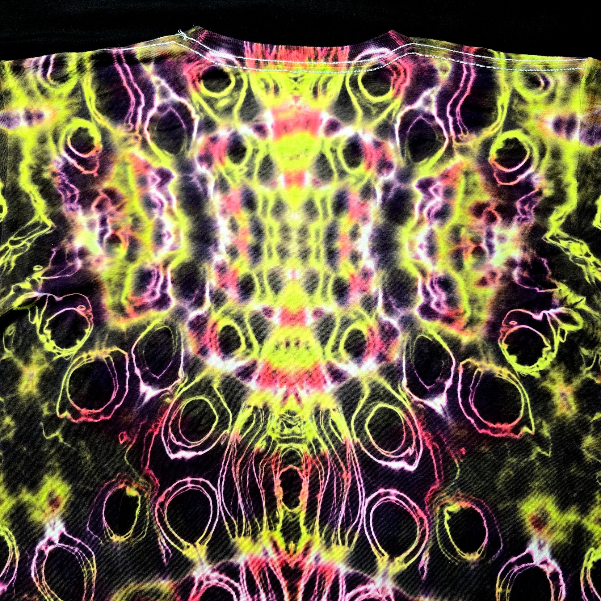 Detailed view of top spine dye work with cellular textures and mirrored saturation
