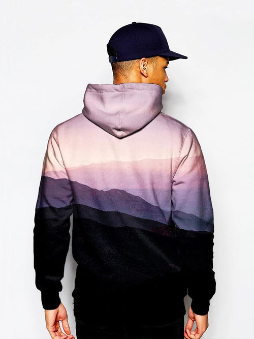 Model in mountain sunrise landscape all over print pullover hoodie