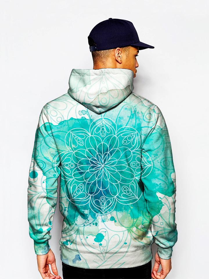 Model wearing blue splotches on white pullover hoodie with mandala art